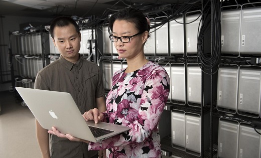 CAPTION Daphne Yao, Virginia Tech associate professor of computer science in the College of Engineering, and her doctoral student Xiaokui Shu check their data for a new piece of software called the program anomaly detection approach.