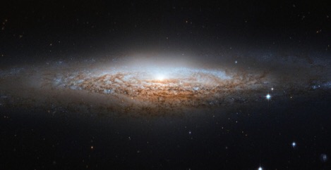 What our Milky Way might look like to alien astronomers: This image of NGC 2683, a spiral galaxy also known as the 'UFO Galaxy' due to its shape, was taken by the Hubble Space Telescope. Since trying to find out what the Milky Way looks like is a bit like trying to picture an unfamiliar house while being confined to a room inside, studies like this one help us gain a better idea of our cosmic home.