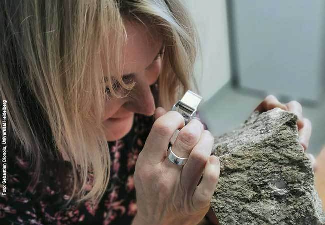 Professor Lucie Tajčmanová, Heidelberg University, examines the whiteschist sample from the Dora Maira Massif of the Western Alps. Photo: Sebastian Cionoiu, Heidelberg University