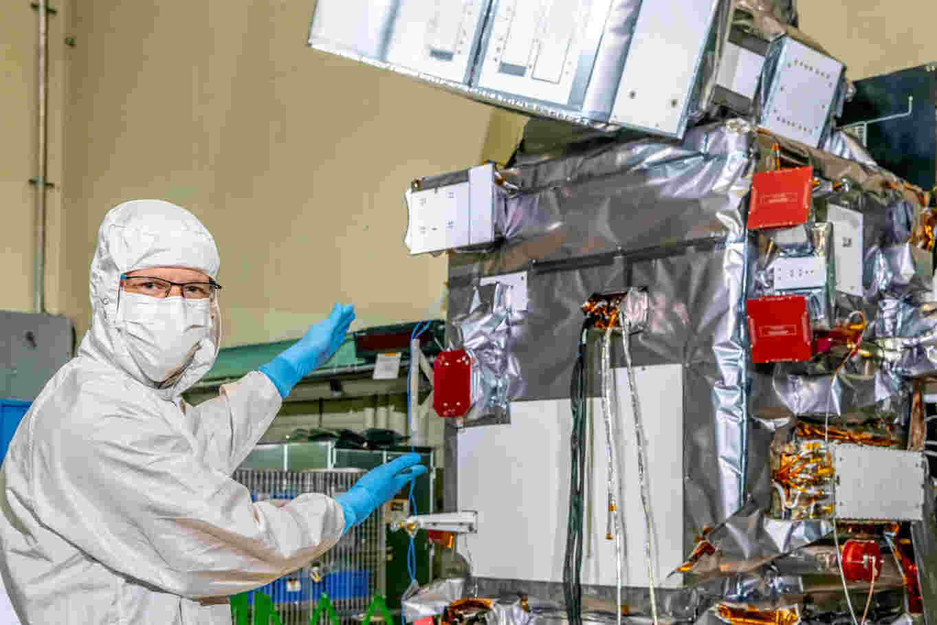 Jeroen Rietjens is pictured in the Goddard cleanroom with the PACE satellite. He expressed his pride at being able to pose with the fully assembled and tested PACE satellite, which hosts their small SPEXone instrument. The instrument is neatly wrapped in grey thermal blankets and still has the red radiator cover in place. Rietjens finds it surreal to realize that in just a few months, it will be staring at the Earth and collecting multi-angle spectro-polarimetric data. This data will enable scientists to infer the amount and type of aerosols in the Earth's atmosphere, contributing to a better understanding of the effects of aerosols on climate. The credit for the photo goes to NASA/Denny Henry.