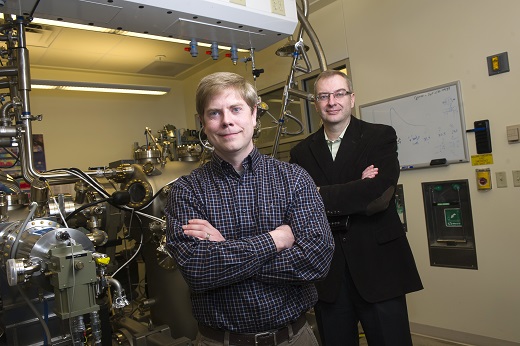 Purdue research engineer and graduate student Geoff Gardner (front) and professor Michael Manfra stand next to a molecular beam epitaxy system in the Manfra laboratories at Discovery Park. Manfra leads Station Q Purdue, an experimental research team collaborating with Microsoft Station Q to pursue a path to quantum computing. (Purdue University photo/Rebecca Wilcox) 