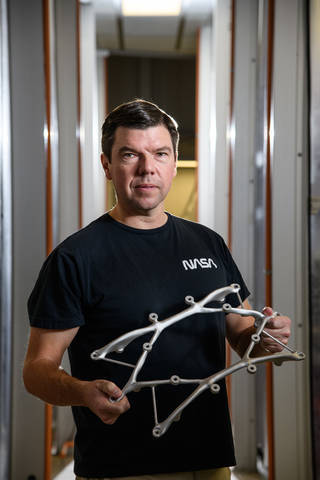 Ryan McClelland displays a structural mount for the Survey and Time-domain Astrophysical Research Explorer (STAR-X) mission. Credits: Henry Dennis