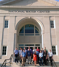 Fred Ogden (back row, in red), a professor in the UW Department of Civil and Architectural Engineering, stands with members of the CI-WATER project team outside the National Water Center recently. Ogden will receive research and development funding from the National Water Center in exchange for the center harnessing his water management model -- technology deemed vital to improving national weather and flood forecasting. (Fred Ogden Photo)