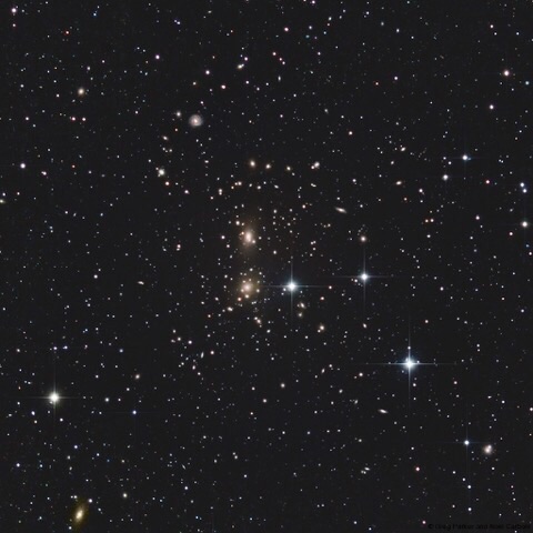 The Coma Galaxy Cluster is a massive cluster of galaxies in the constellation Coma Berenices. Each point of light in this image may look like a star but in fact they are, mostly galaxies. With over 650 galaxies in the cluster, Abell 1656 is one of the densest collections of galaxies in the entire sky. Credit: Greg Parker, New Forest Observatory. The Coma Galaxy Cluster is a massive cluster of galaxies in the constellation Coma Berenices. Each point of light in this image may look like a star but in fact they are, mostly galaxies. With over 650 galaxies in the cluster, Abell 1656 is one of the densest collections of galaxies in the entire sky. Credit: Greg Parker, New Forest Observatory.
