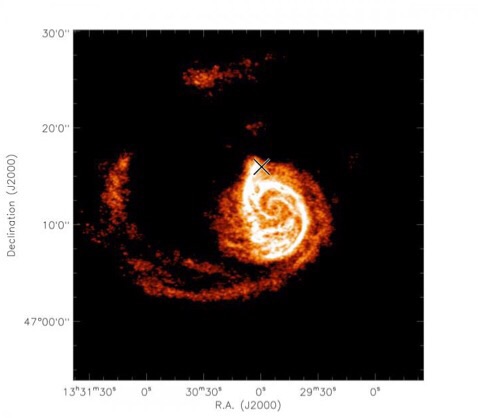 CAPTION This image, captured by the Very Large Array, shows the atomic hydrogen distribution of the Whirlpool Galaxy. The "X" marks the dwarf companion satellite. Dynamical simulations can recover its location and mass. CREDIT VLA, Chakrabarti et al. 2011 CAPTION This image, captured by the Very Large Array, shows the atomic hydrogen distribution of the Whirlpool Galaxy. The "X" marks the dwarf companion satellite. Dynamical simulations can recover its location and mass. CREDIT VLA, Chakrabarti et al. 2011