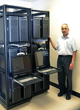 Suresh Muknahallipatna, a UW professor of electrical and computer engineering, stands next to the computer racks that make up the Electrical and Computer Engineering High Performance Cluster (ECE-HPC). UW Professors Develop ECE-HPC Supercomputer