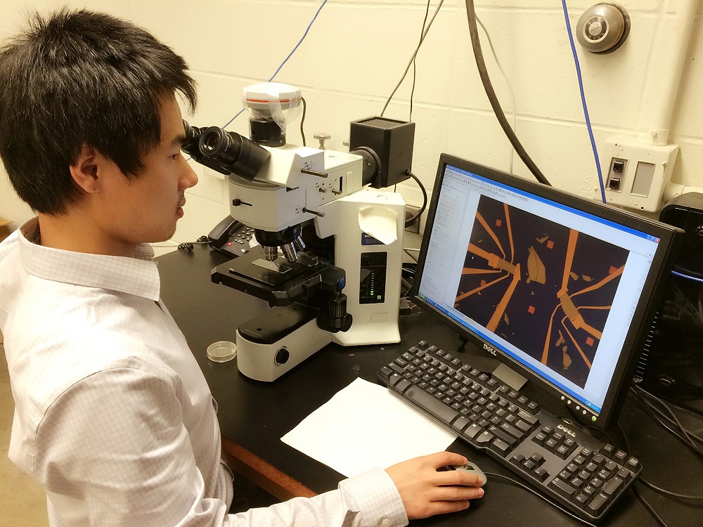 Purdue University doctoral student Yang Xu, lead author of a new research paper on "topological insulators," an emerging class of materials that could make possible "spintronic" devices and practical quantum computers far more powerful than today's technologies, is shown here inspecting devices made from topological insulators under a microscope before electrical measurements. (Purdue University photo / Ting-fung Chung) Purdue University doctoral student Yang Xu, lead author of a new research paper on "topological insulators," an emerging class of materials that could make possible "spintronic" devices and practical quantum computers far more powerful than today's technologies, is shown here inspecting devices made from topological insulators under a microscope before electrical measurements. (Purdue University photo / Ting-fung Chung)