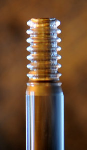 Stack of quartz optical cavities -- precisely machined disks of solid quartz crystal -- for use in NIST's compact laser frequency comb. (Only one is actually used.) A low-power infrared laser produces light that travels in a loop inside one of the cavities. Each cavity is 2 millimeters wide and shaped like a flat ellipse. Credit: S. Papp/NIST Stack of quartz optical cavities -- precisely machined disks of solid quartz crystal -- for use in NIST's compact laser frequency comb. (Only one is actually used.) A low-power infrared laser produces light that travels in a loop inside one of the cavities. Each cavity is 2 millimeters wide and shaped like a flat ellipse. Credit: S. Papp/NIST