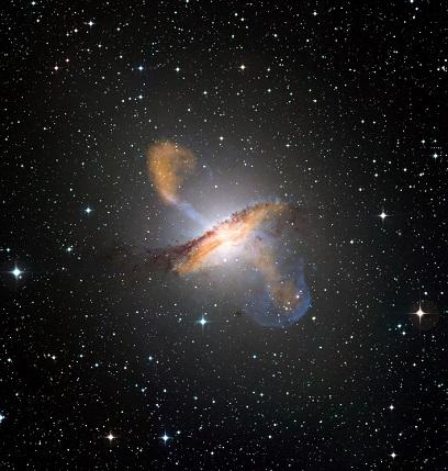 Colour composite image of Centaurus A, revealing the lobes and jets emanating from the active galaxy’s central black hole. Credit: ESO/WFI (Optical); MPIfR/ESO/APEX/A.Weiss et al. (Submillimetre); NASA/CXC/CfA/R.Kraft et al. (X-ray)