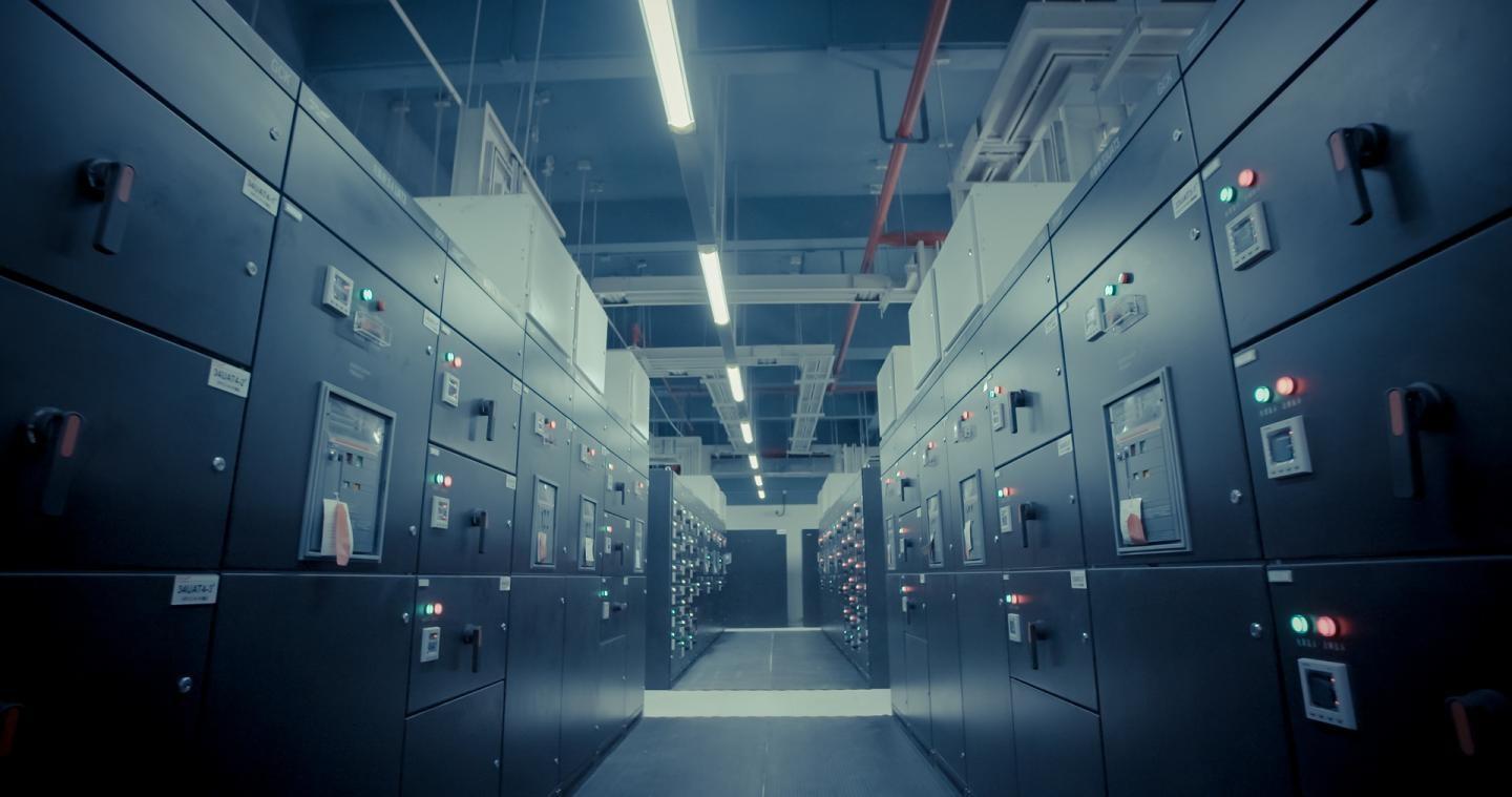 Computing consumes 8% of global electricity, largely in massive, factory-sized data centres. This already-unsustainable energy load that is doubling every decade.