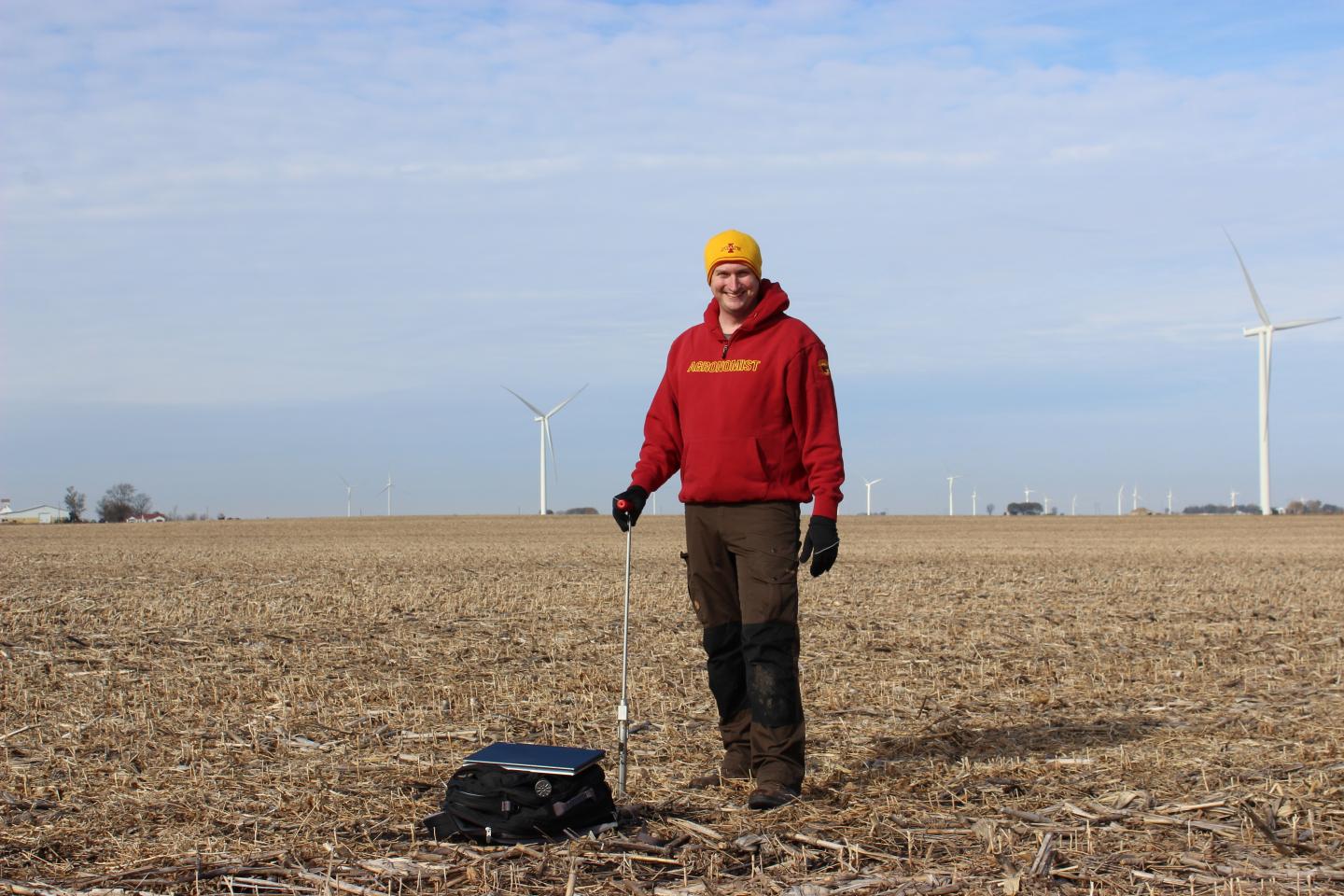 Bradley Miller takes soil samples from a field. Part of Miller's research aims to bridge geomorphology, or the study of how landforms change over time, with soil science