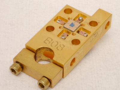 This NIST device, 1.5 by 3 centimeters in outer dimensions, is a prototype receiver for laser communications enabling much higher data rates than conventional systems. Superconducting detectors in the center of the small square chip register the timing and position of single particles of light. By Verma and Tomlin/NIST This NIST device, 1.5 by 3 centimeters in outer dimensions, is a prototype receiver for laser communications enabling much higher data rates than conventional systems. Superconducting detectors in the center of the small square chip register the timing and position of single particles of light. By Verma and Tomlin/NIST
