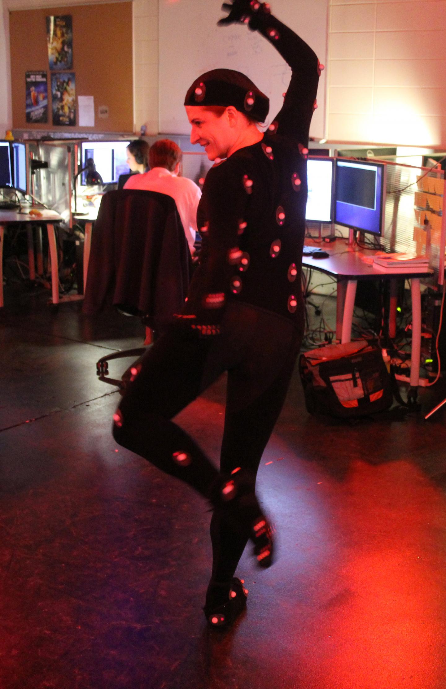 Report co-author Alison Leonard shows off the motion capture suit used in this study. Her research focuses on engaging students in computer programming. Report co-author Alison Leonard shows off the motion capture suit used in this study. Her research focuses on engaging students in computer programming.