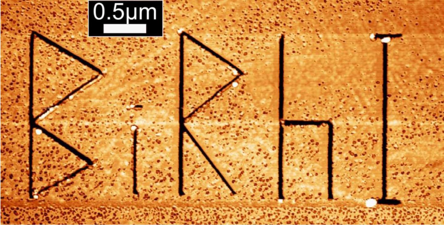 Microscopic image of the topological insulator Bismuth-Rhodium-Iodine (Bi14Rh3I9). The engraved letters BiRhI act as artificially introduced steps at the crystal surface. Credit M. Morgenstern, RWTH Aachen Microscopic image of the topological insulator Bismuth-Rhodium-Iodine (Bi14Rh3I9). The engraved letters BiRhI act as artificially introduced steps at the crystal surface. Credit M. Morgenstern, RWTH Aachen