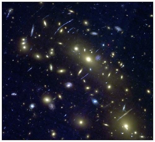 Hubble Space Telescope image of the cluster of galaxies MACS0416.1-2403, one of the Hubble ‘Frontier Fields’. Bright yellow ‘elliptical’ galaxies can be seen, surrounded by numerous blue spiral and amorphous (star-forming) galaxies. Gravitational arcs can also be seen. This image forms the test data that the machine learning algorithm is applied to, having not previously ‘seen’ the image. Credit: NASA / ESA / J. Geach / A. Hocking. Hubble Space Telescope image of the cluster of galaxies MACS0416.1-2403, one of the Hubble ‘Frontier Fields’. Bright yellow ‘elliptical’ galaxies can be seen, surrounded by numerous blue spiral and amorphous (star-forming) galaxies. Gravitational arcs can also be seen. This image forms the test data that the machine learning algorithm is applied to, having not previously ‘seen’ the image. Credit: NASA / ESA / J. Geach / A. Hocking.