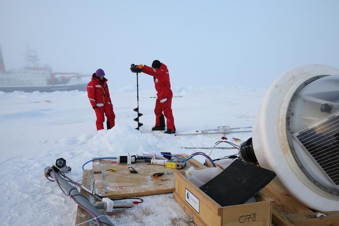 Scientists install buoys on an ice floe in the Central Arctic Ocean at the end of the MOSAiC leg 5 with RV Polarstern in September 2020. The buoys are working as an autonomous bio-physical observatory on sea ice and in the ocean. The observatory consisted, among other components, of an Acoustic Zooplankton and Fish Profiler (AZFP) measuring acoustic backscatter in the top 50 m of the ocean, a radiation station equipped with hyperspectral light sensors measuring irradiance at the ice underside between 350 and 920 nm25, and a CTD buoy (conductivity, temperature, depth).  CREDIT Alfred Wegener Instittue / Folke Mehrtens