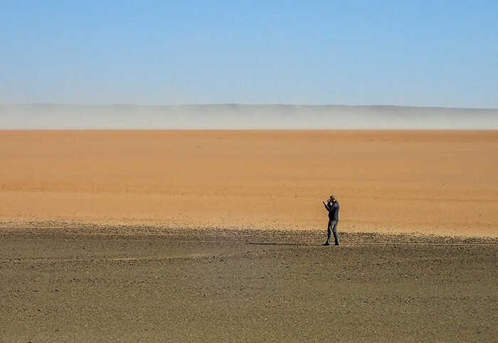 Brian Stewart surveying the extensive scatters of stone artefacts observed along the margin of a now-dry lakebed near Swartkolkvloer. CREDIT Brian Chase Brian Stewart surveying the extensive scatters of stone artefacts observed along the margin of a now-dry lakebed near Swartkolkvloer. CREDIT Brian Chase