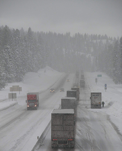 Cars and trucks facing heavy snow on Interstate 84 in Oregon. A new digital intelligence system that equips snowplows with custom-designed sensors is helping transportation officials clear winter roads more quickly and effectively. (Image courtesy Wikimedia Commons/Oregon Department of Transportation.) New technology targets slick winter highways