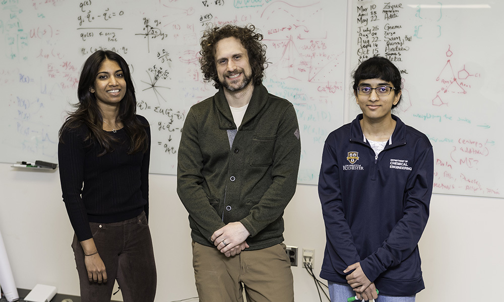 From left: PhD student Geemi Wellawatte, Andrew White, an associate professor of chemical engineering, and Aditi Seshadri ’22 in Wegmans Hall. White’s lab has developed a way to verify the predictions of machine learning models used in drug discovery by using counterfactuals. (University of Rochester photo / J. Adam Fenster)