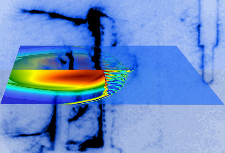 Laser beams illuminate a small carbon rod and launch an asymmetric shock inside a chamber filled with argon gas. A grid is placed in the shock's path, 1 centimetre from the target, resulting in turbulent flow. The shock and the turbulent flow is captured with the Schlieren imaging technique (blue-black hues) at 300 billionth of a second after the laser shot. The electron density predicted by computer simulations (blue-red hues) is superimposed. Laser beams illuminate a small carbon rod and launch an asymmetric shock inside a chamber filled with argon gas. A grid is placed in the shock's path, 1 centimetre from the target, resulting in turbulent flow. The shock and the turbulent flow is captured with the Schlieren imaging technique (blue-black hues) at 300 billionth of a second after the laser shot. The electron density predicted by computer simulations (blue-red hues) is superimposed.