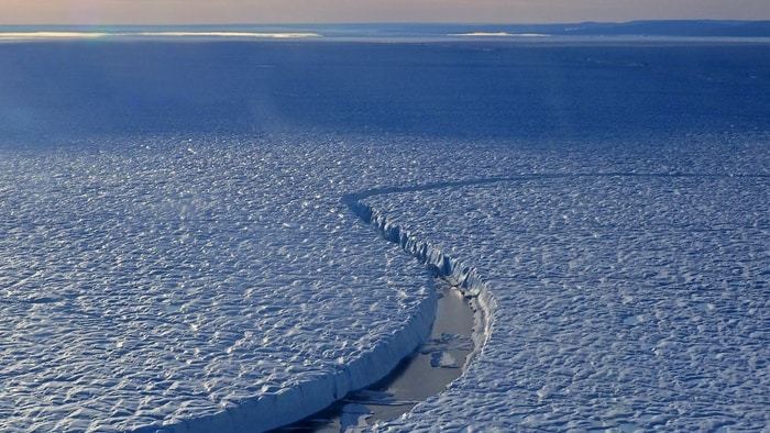 A crack in Petermann Ice Shelf observed by an international team of scientists during the Oden expedition in 2019. These cracks can eventually grow across the entire ice shelf, leading to the release of large icebergs to the ocean and potentially breakup of the ice shelf. Photo: Martin Jakobsson  CREDIT Photo: Martin Jakobsson