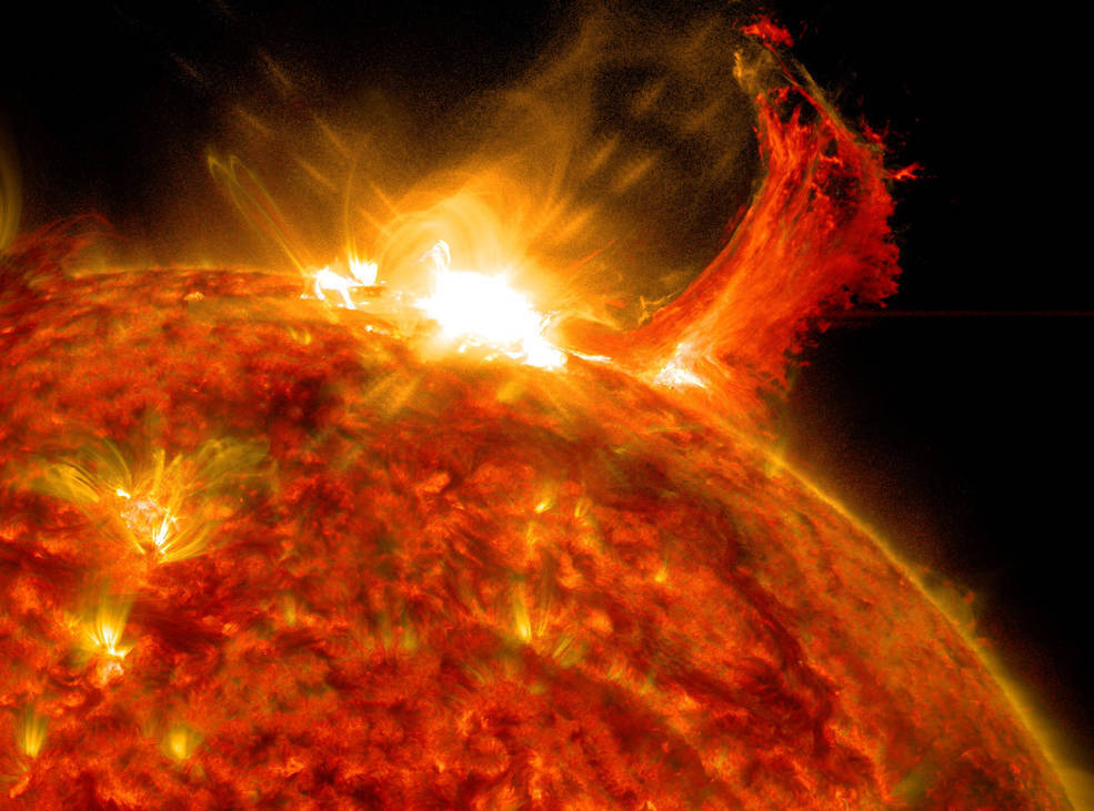 NASA's Solar Dynamics Observatory captured this image of a solar flare on Oct. 2, 2014. The solar flare is the bright flash of light at top. A burst of solar material erupting out into space can be seen just to the right of it. Credits: NASA/SDO NASA's Solar Dynamics Observatory captured this image of a solar flare on Oct. 2, 2014. The solar flare is the bright flash of light at top. A burst of solar material erupting out into space can be seen just to the right of it. Credits: NASA/SDO