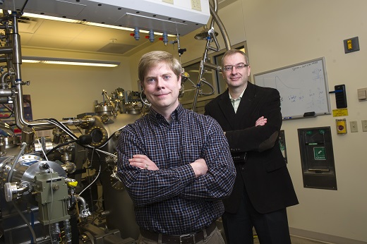 Purdue research engineer and graduate student Geoff Gardner (front) and professor Michael Manfra stand next to a molecular beam epitaxy system in the Manfra laboratories at Discovery Park. Manfra leads Station Q Purdue, an experimental research team collaborating with Microsoft Station Q to pursue a path to quantum computing. (Purdue University photo/Rebecca Wilcox) Purdue research engineer and graduate student Geoff Gardner (front) and professor Michael Manfra stand next to a molecular beam epitaxy system in the Manfra laboratories at Discovery Park. Manfra leads Station Q Purdue, an experimental research team collaborating with Microsoft Station Q to pursue a path to quantum computing. (Purdue University photo/Rebecca Wilcox)