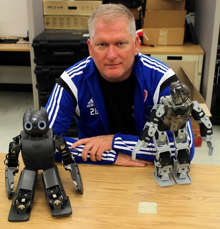 Eric Matson, Purdue University associate professor of computer and information technology, with a couple friends (small, commercially available programmable robots that he uses in his robotics class and research.) Matson's research focuses on the intersection of technologies such as robotics, artificial intelligence and sensor networks and he’s involved in developing firefighting robots and robots to assist senior citizens in living independently. Eric Matson, Purdue University associate professor of computer and information technology, with a couple friends (small, commercially available programmable robots that he uses in his robotics class and research.) Matson's research focuses on the intersection of technologies such as robotics, artificial intelligence and sensor networks and he’s involved in developing firefighting robots and robots to assist senior citizens in living independently.