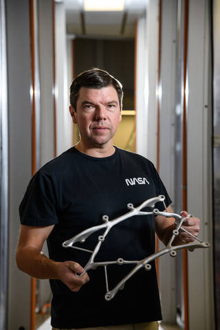 Ryan McClelland displays a structural mount for the Survey and Time-domain Astrophysical Research Explorer (STAR-X) mission. Credits: Henry Dennis Ryan McClelland displays a structural mount for the Survey and Time-domain Astrophysical Research Explorer (STAR-X) mission. Credits: Henry Dennis