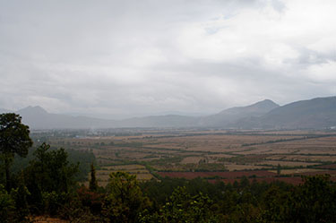 Rain rolls in on agricultural land during the monsoon season in Lijang, Yunnan, China. (Creative Commons photo by Aidan Whiteley.) Geoengineering the climate could reduce vital rains