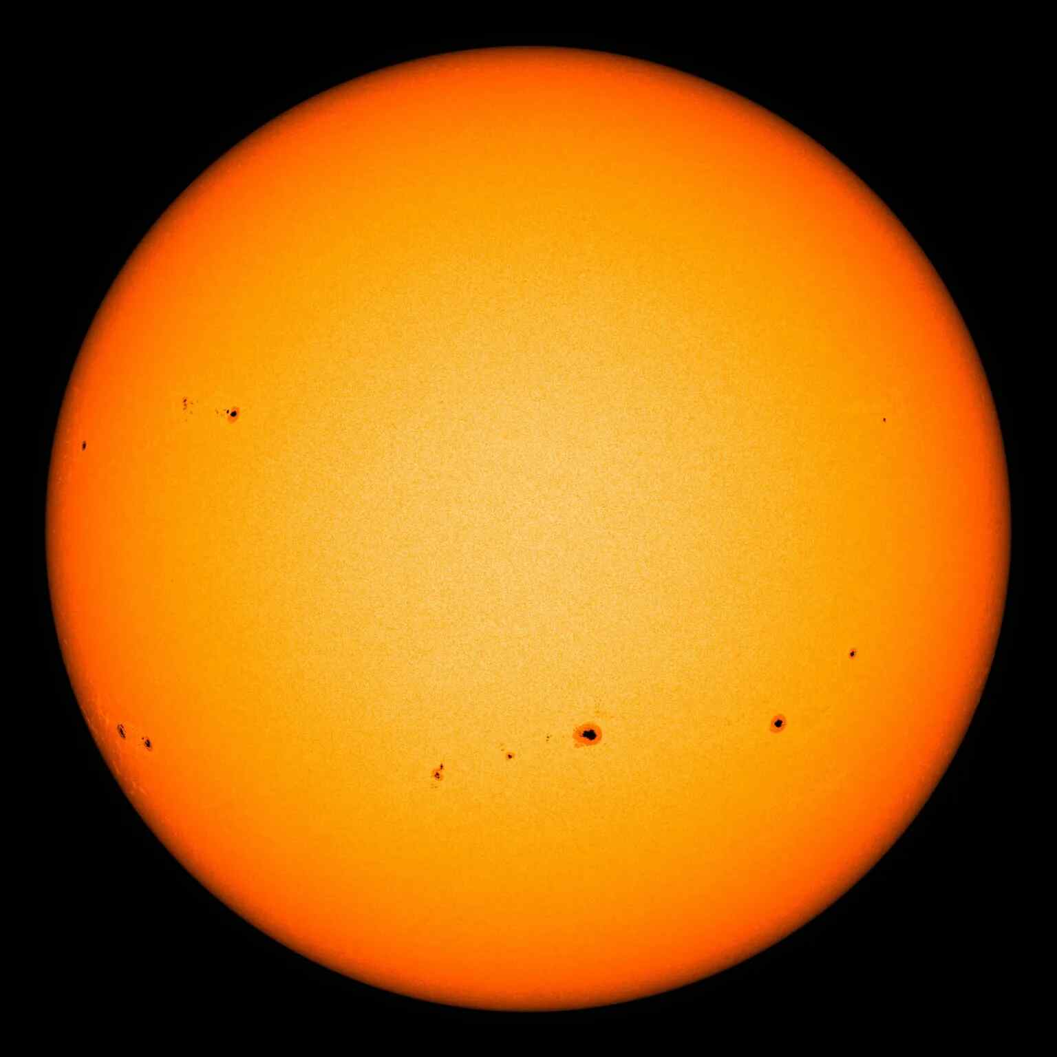 This is an image of the Sun captured by NASA's Solar Dynamics Observatory in August 2012. The image displays various sunspots. Just like our Sun, other stars also have starspots that cause the observed brightness to fluctuate as the spots rotate in and out of view. Astronomers can determine the rotation period of a star by measuring these brightness changes. NASA's Nancy Grace Roman Space Telescope will collect brightness measurements for numerous stars located towards the center of our Milky Way galaxy. This will provide vital information about their rotation rates. The data collected could be useful in understanding how stars and planetary systems form and evolve. 