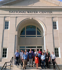 Fred Ogden (back row, in red), a professor in the UW Department of Civil and Architectural Engineering, stands with members of the CI-WATER project team outside the National Water Center recently. Ogden will receive research and development funding from the National Water Center in exchange for the center harnessing his water management model -- technology deemed vital to improving national weather and flood forecasting. (Fred Ogden Photo) Fred Ogden (back row, in red), a professor in the UW Department of Civil and Architectural Engineering, stands with members of the CI-WATER project team outside the National Water Center recently. Ogden will receive research and development funding from the National Water Center in exchange for the center harnessing his water management model -- technology deemed vital to improving national weather and flood forecasting. (Fred Ogden Photo)